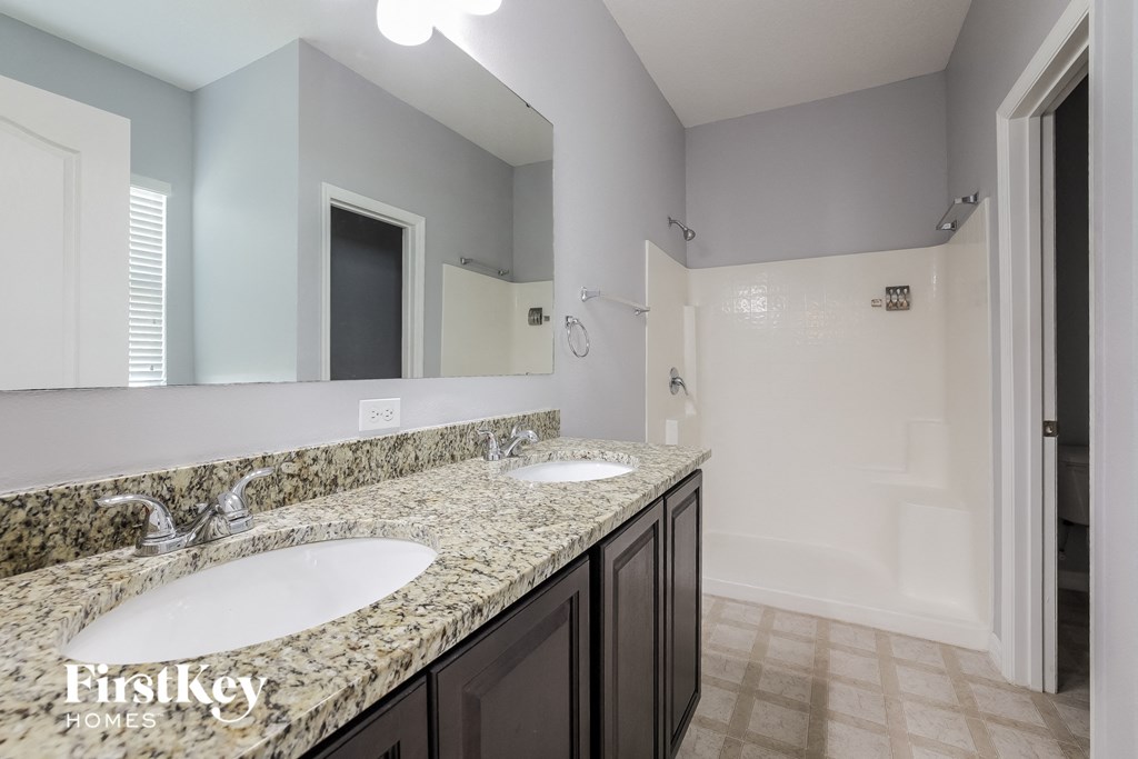 a bathroom with two sinks and a large mirror