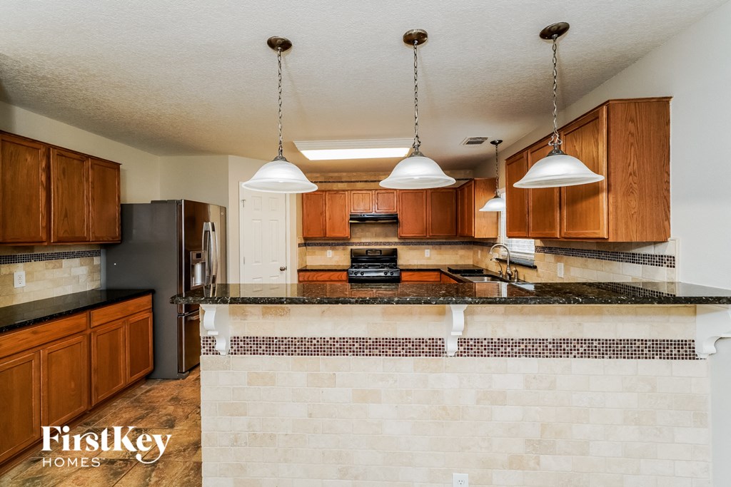 a kitchen with wooden cabinets and a counter top