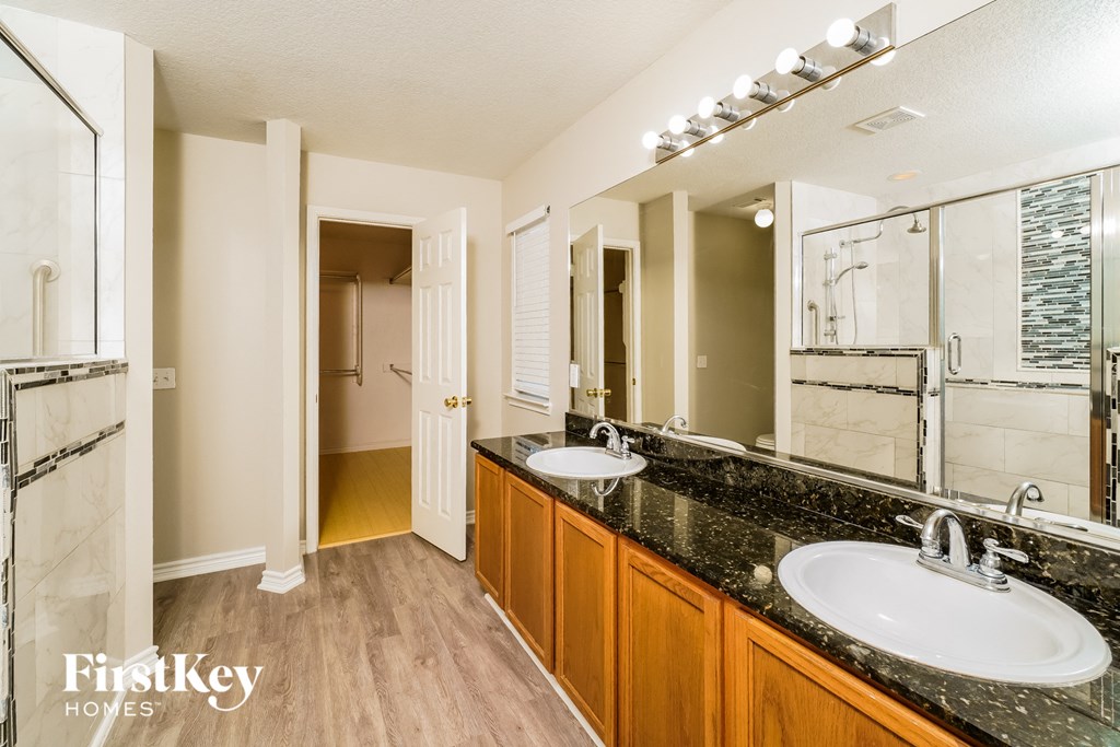 a bathroom with two sinks and a large mirror