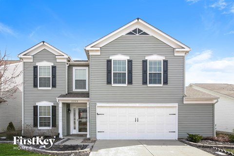 a gray house with a white garage door