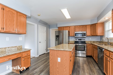 a kitchen with wooden cabinets and stainless steel appliances