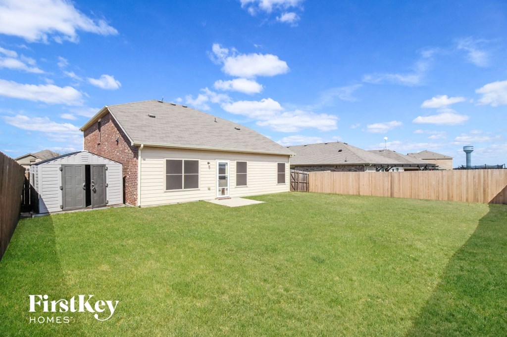 A house with a fence and a grassy yard.