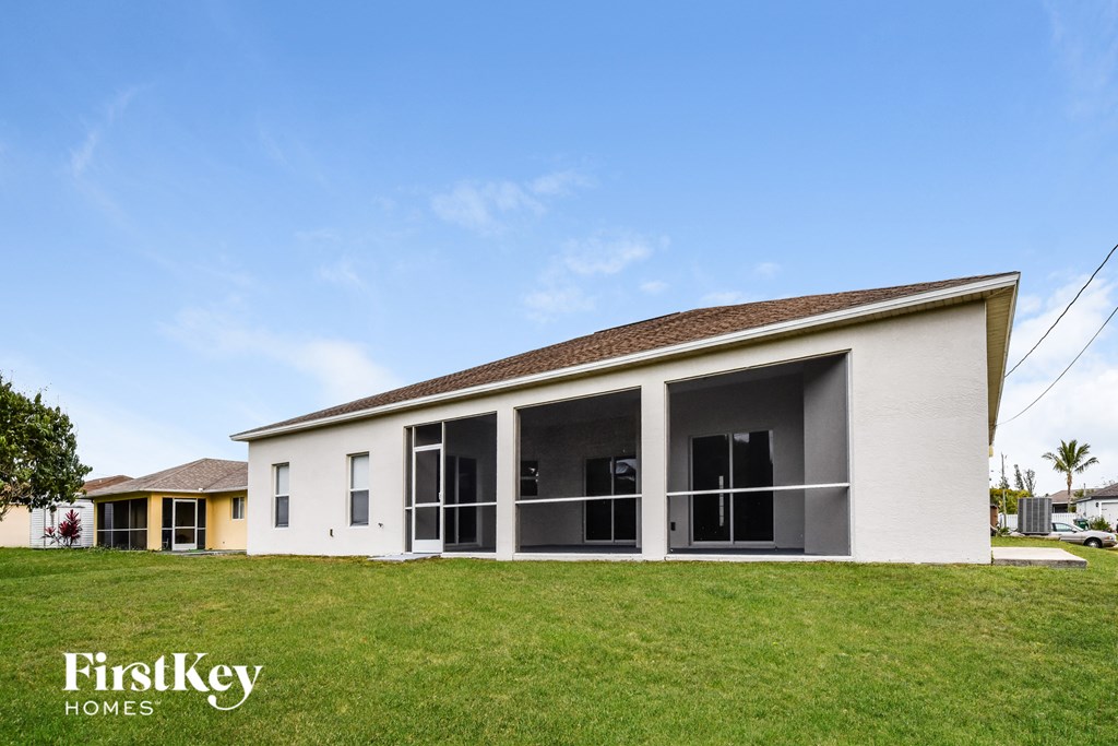 a small white house with a lawn in front of it
