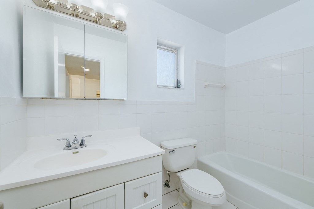 a bathroom with a sink toilet and a bath tub