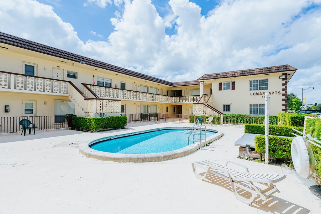 a swimming pool in front of a building with a pool
