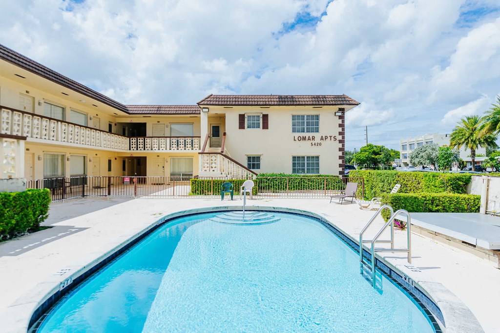 a swimming pool with a building in the background