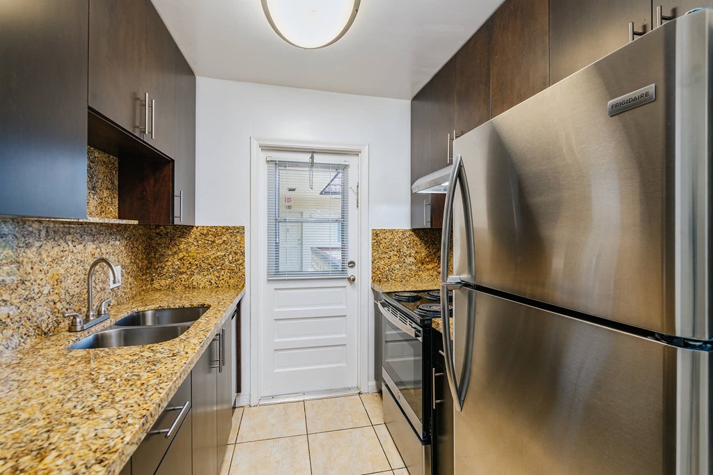 a kitchen with stainless steel appliances and granite counter tops