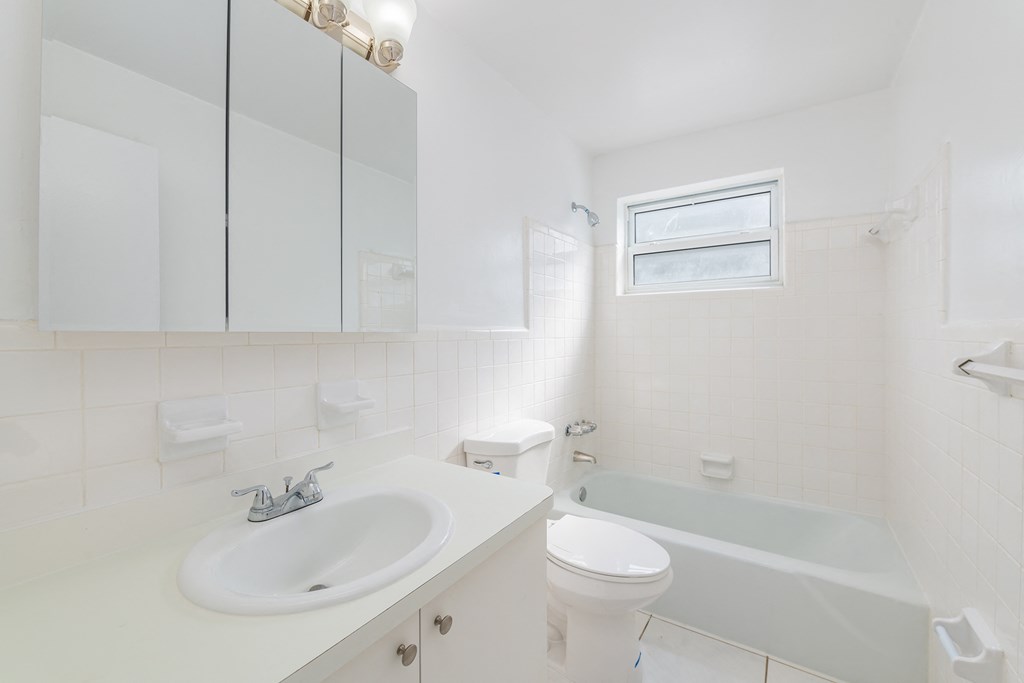 a bathroom with a sink toilet and a bath tub