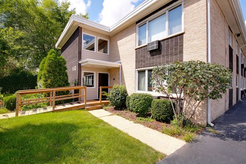 A house with a brown brick exterior and a white window.