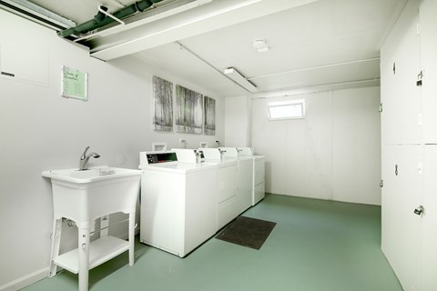 A bathroom with a white sink and a white cabinet.