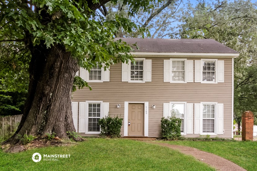 a house with a large tree in front of it