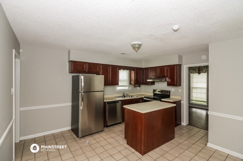 a kitchen with stainless steel appliances and wooden cabinets
