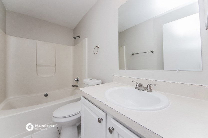 a bathroom with a sink and a toilet and a tub