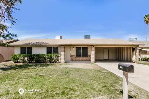 a house with a driveway and a mailbox in front of it