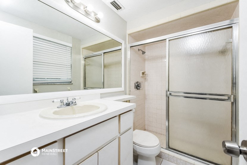 a bathroom with a sink toilet and a shower