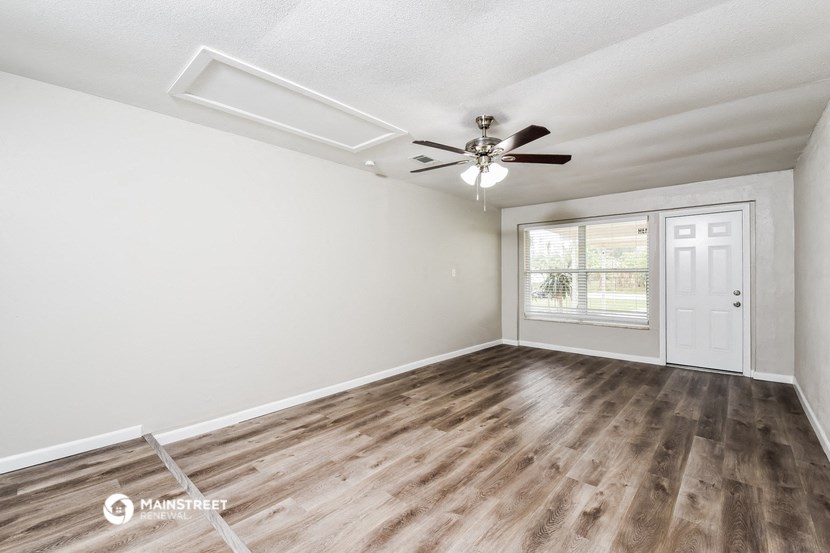 the living room of our studio apartment atrium with a ceiling fan