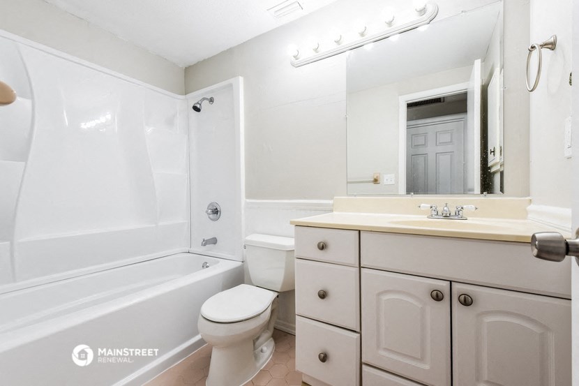 a bathroom with a sink toilet and a bath tub