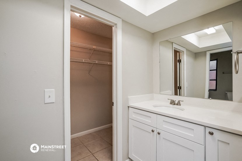 a bathroom with a sink and a mirror and a shower