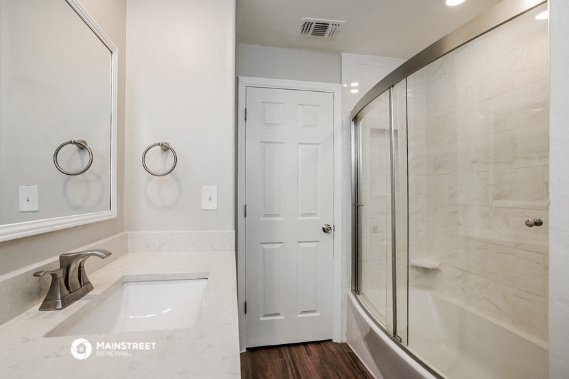 the master bathroom has a large shower and a sink