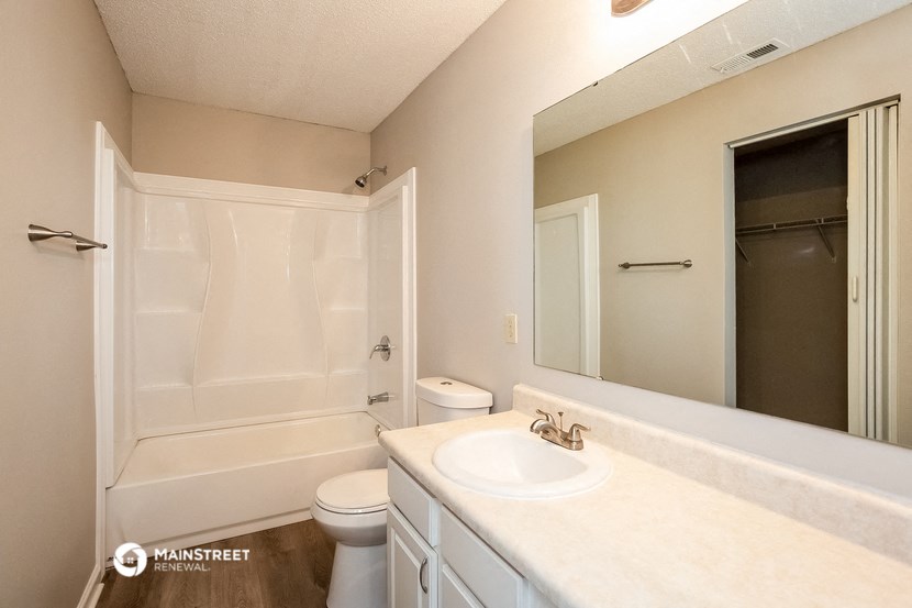 a bathroom with a sink and a shower and a toilet