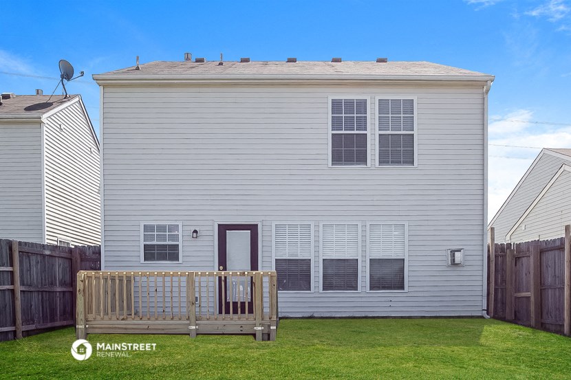 a white house with a wooden bench in front of it