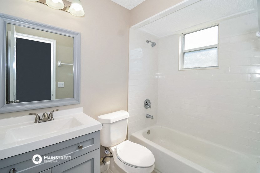 a bathroom with a sink toilet and a bath tub