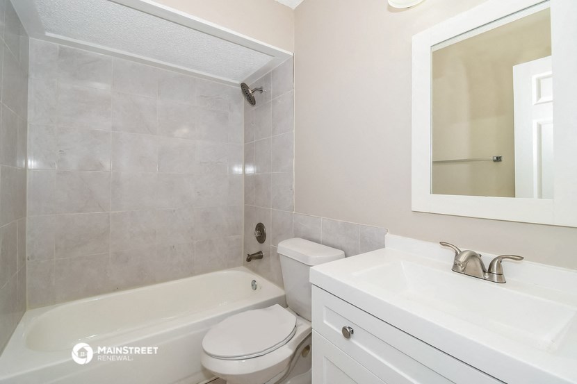 a bathroom with a sink toilet and a bath tub
