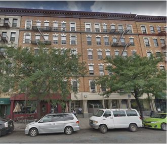 a view of a building with cars parked in front of it