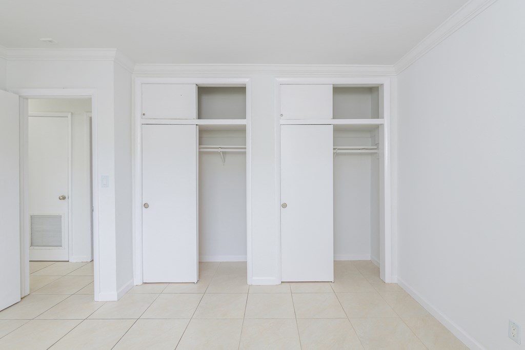 an empty room with four closet doors in it