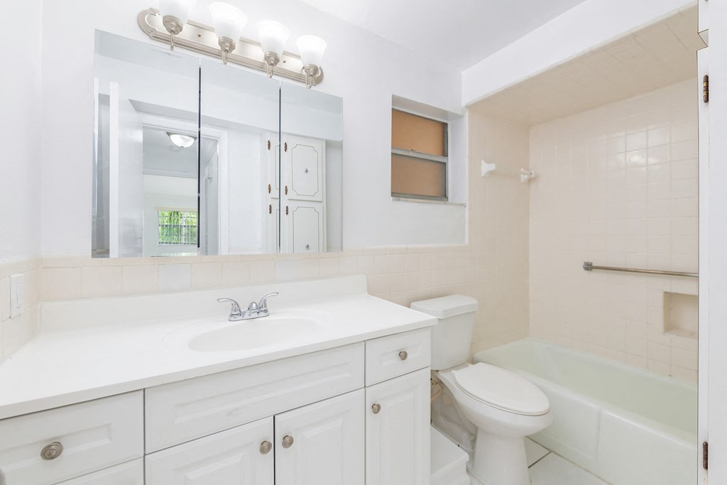 a bathroom with a sink toilet and a tub