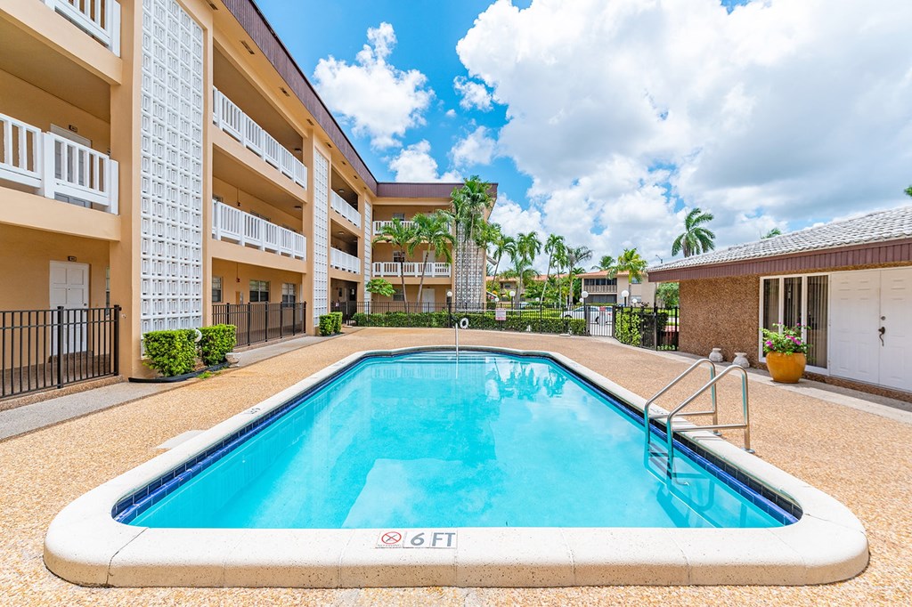 the swimming pool at the conclusion of an apartment building with a pool