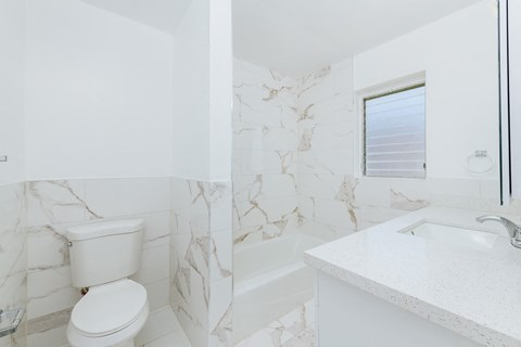 a white bathroom with a toilet and a sink