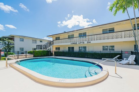 a swimming pool with a building in the background