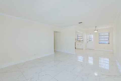 an empty living room with white marble floors and white walls