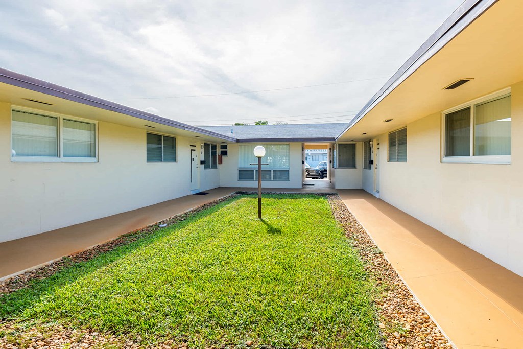 a long hallway with a yard and a house