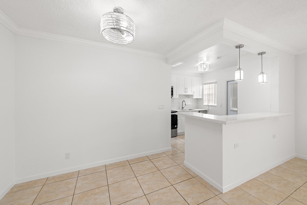 a view of a kitchen and a living room with tile flooring
