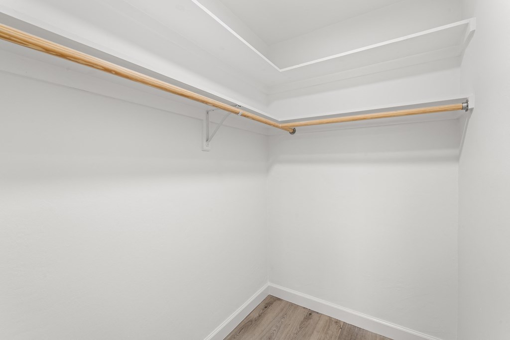 an empty room with white walls and a wooden floor