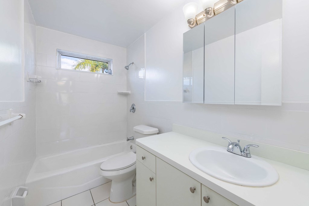 a white bathroom with a sink and a toilet