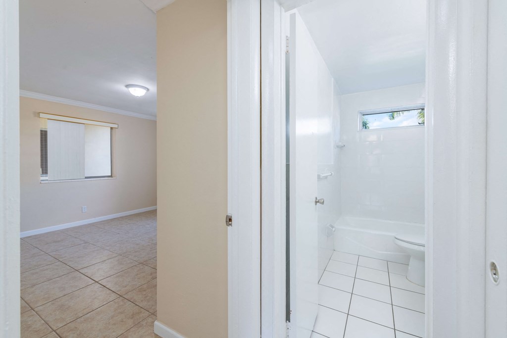 an empty bathroom with a shower and a toilet