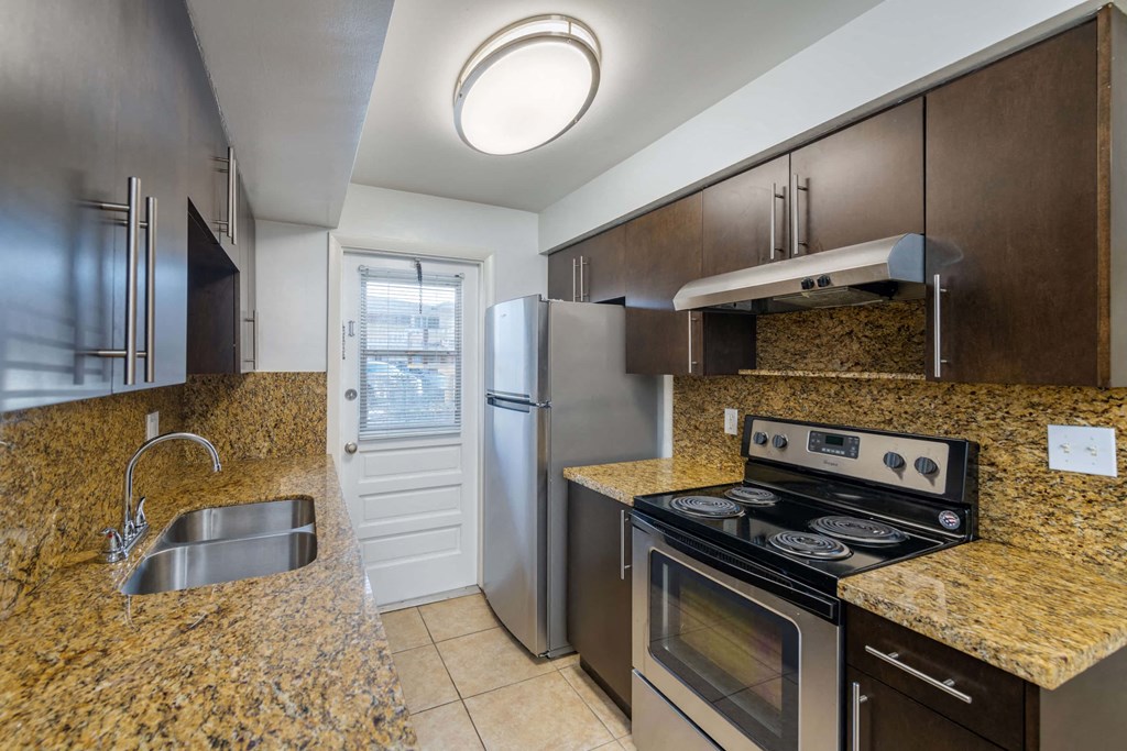a kitchen with stainless steel appliances and granite counter tops