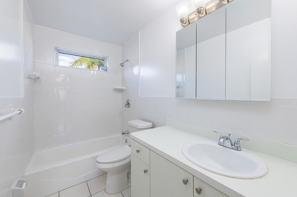 a white bathroom with a sink and a toilet