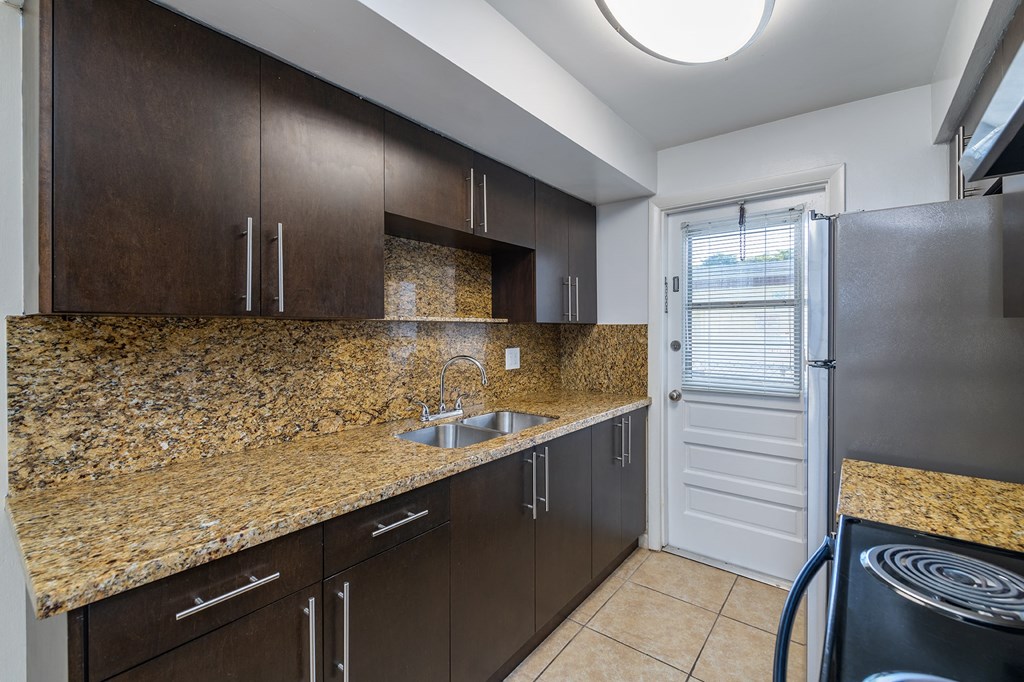 kitchen with stainless steel appliances and granite counter tops and a stainless steel refrigerator