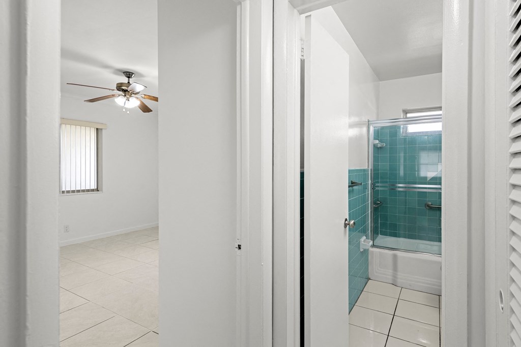 the view of the bathroom from the bedroom with the door open