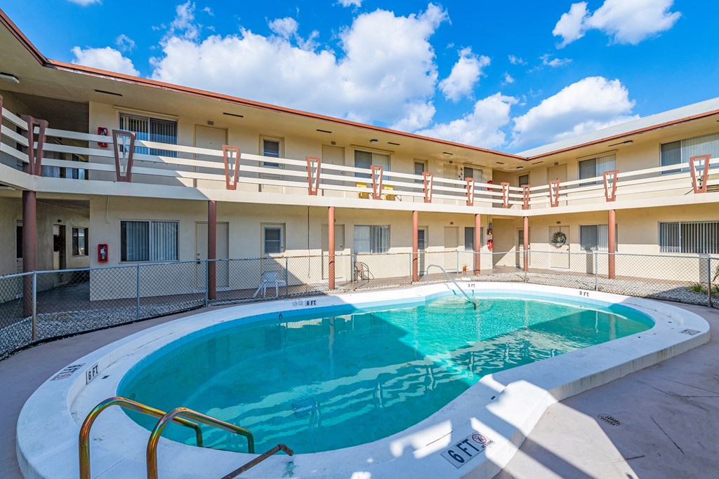 a swimming pool in the middle of a hotel pool