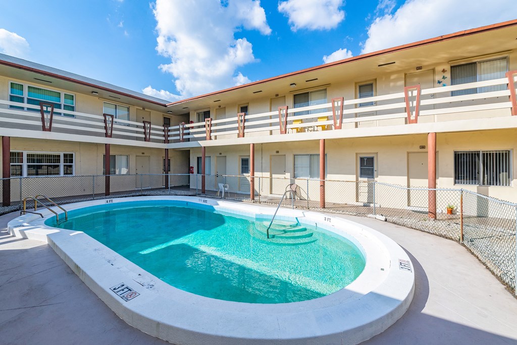 a swimming pool with a fountain in the middle of a building