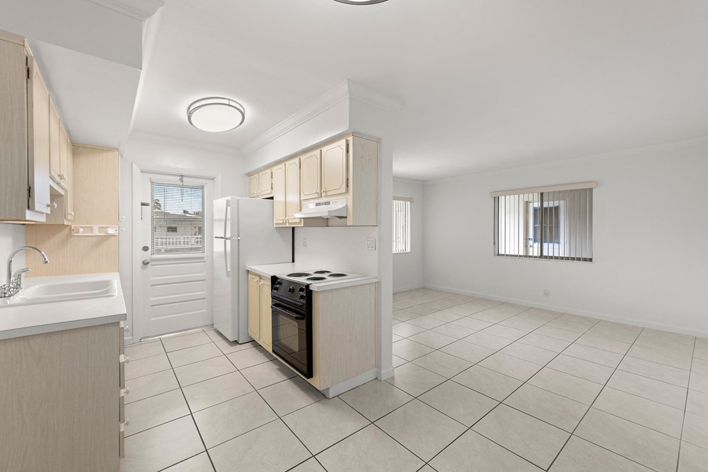 a kitchen with a stove and a refrigerator and a sink