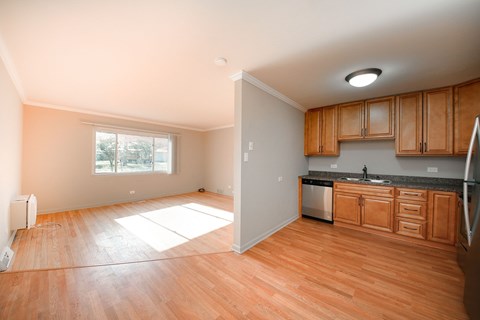 A kitchen with wooden cabinets and a refrigerator.