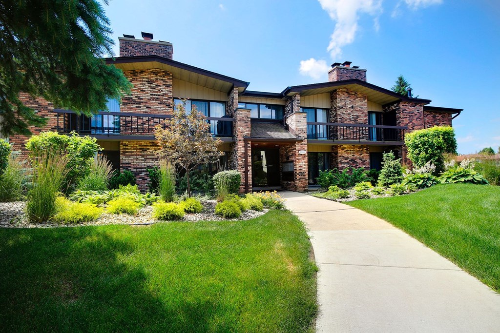 a large house with a sidewalk in front of it