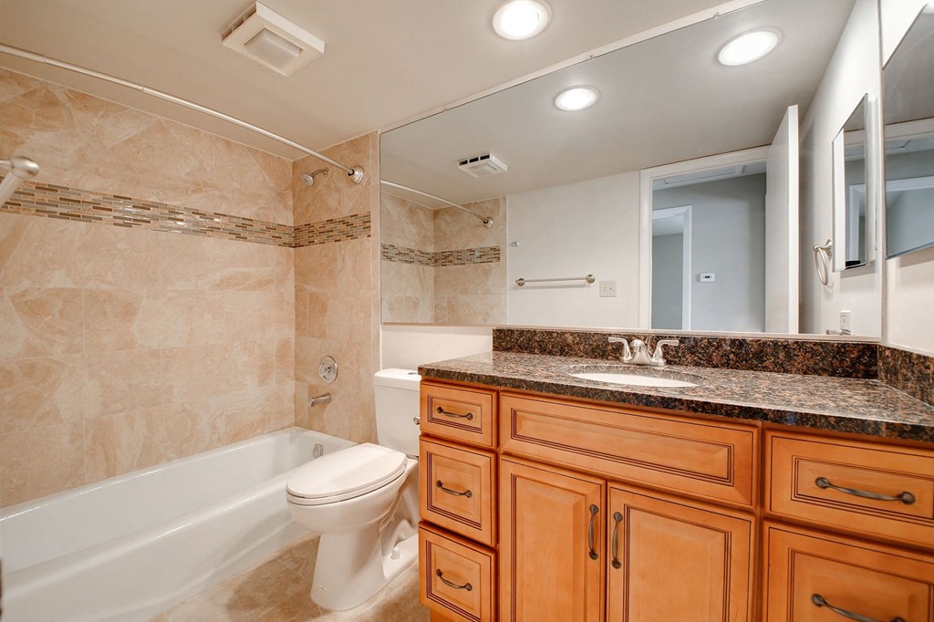 a bathroom with a toilet and a sink and a tub