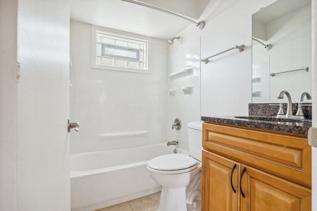 a bathroom with a shower and a toilet and a sink